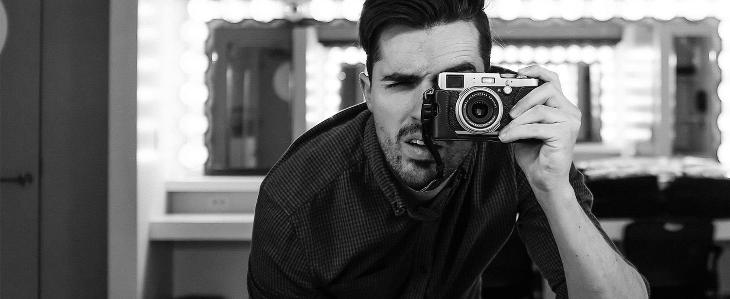man holding a camera black and white