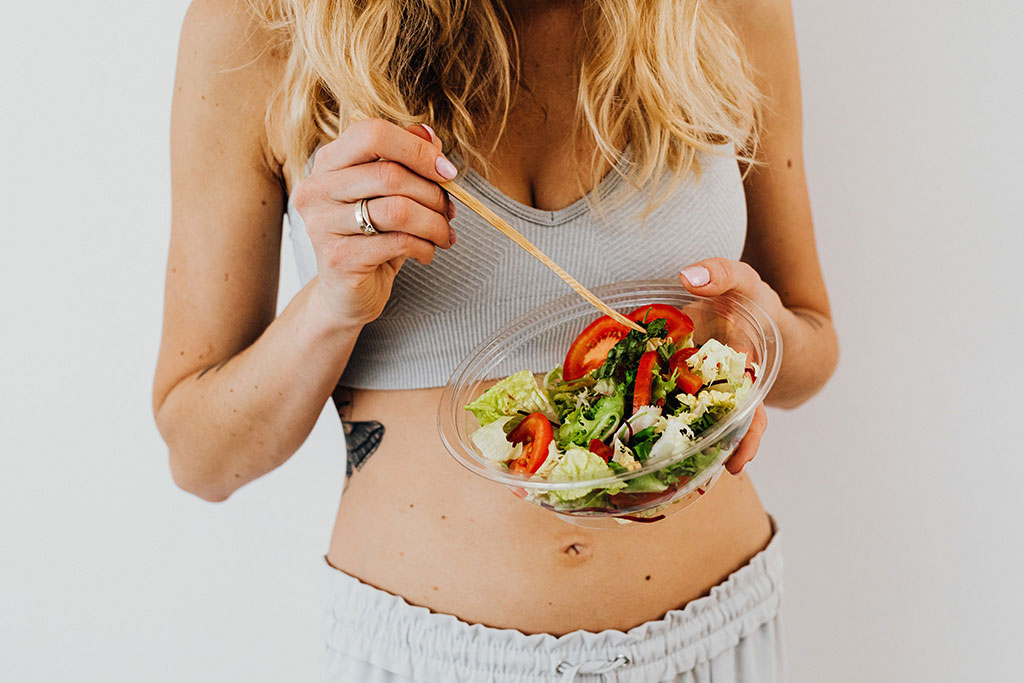 female model holding salad